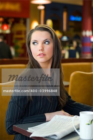 pretty business woman in formal dress sitting in a cafe