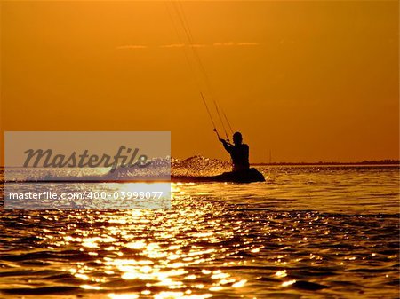 Silhouette of a kite-surf on waves of a gulf on a sunset 2