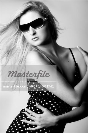 Beautiful girl with a pair off sunglasses in the studio