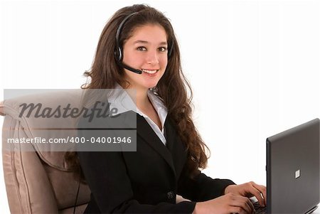 Beautiful professionally dressed customer representative with her headset and computer