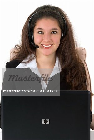 Beautiful professionally dressed businesswoman with her headset and computer