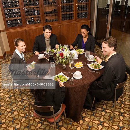 High angle of group of businesspeople in restaurant dining.