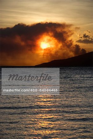 Dark clouds at sunset over water on Maui, Hawaii.