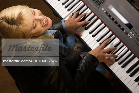 Female Musician Sings While Playing Digital Piano