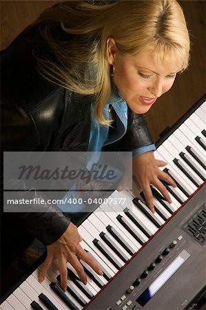 Female Musician Sings While Playing Digital Piano