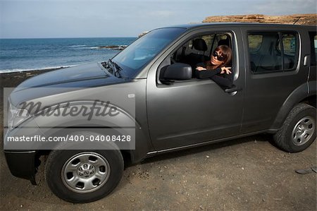 Woman and her 4wd car at Fuerteventura's beach