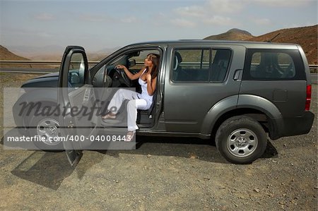 Woman and her 4wd car at Fuerteventura's offroad