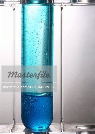 Test tube with a dark blue liquid on a white background Test tube with a dark blue liquid on a white background