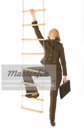 An isolated photo of a businesswoman climbing a rope-ladder