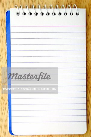spiral bound notepad on a wood surface