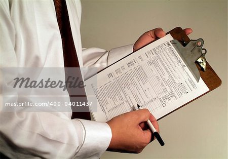 man in suit holding tax form