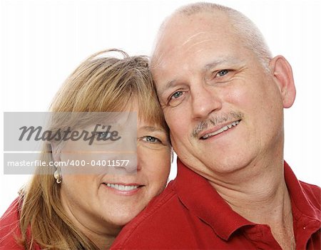 Closeup headshot of a mature couple in love.  White background.
