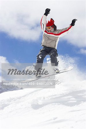 snowboarder taking jump in fresh powder snow