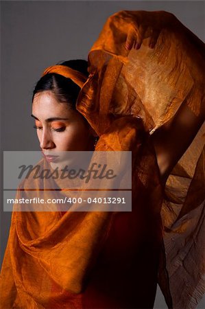 Portrait of hispanic dancer with orange veil