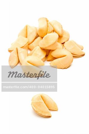 fortune cookie single with pile in the background, closeup isolated on white