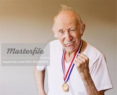 Senior Citizen Posing with a Gold Medal