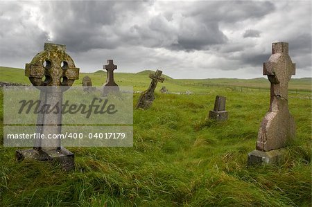 Ancient Celtic gravesite with unmarked gravestones from the 1600's in the middle of a meadow in rural Scotland.