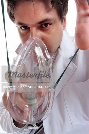 A doctor leaning over a patient to stretching the elastic to place an oxygen mask on their face.  Could also be anesthesia or laughing gas.   From patient perspective.