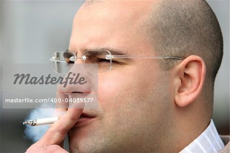 Close up shot of an smoking man