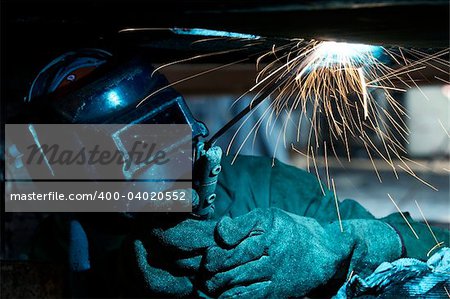 a welder working at shipyard during day