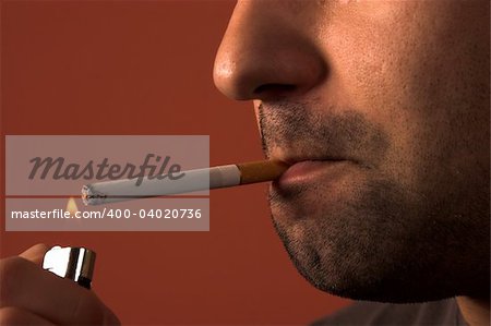 close up of an man lighting a cigarette