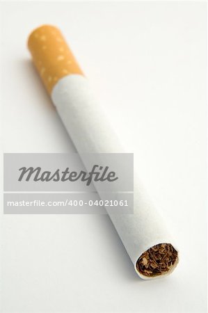 single cigarette on white background, diagonal orientation, distance blur