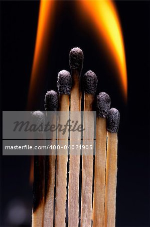 Burning matches, black background