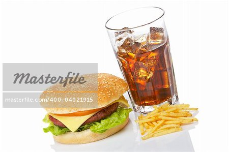 Cheeseburger, soda drink and french fries, reflected on white background. Shallow depth of field