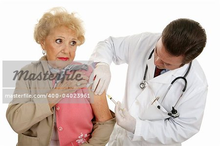 Senior woman getting a vaccination from the doctor.  Isolated on white.