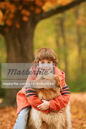 Boy Hugging the Dog in the Fall