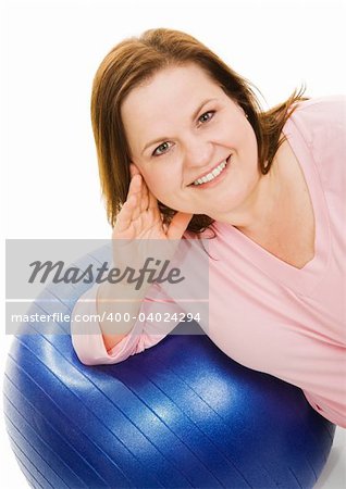 Beautiful plus sized woman resting on a pilates workout ball.  Isolated on white.