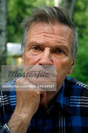 Portrait of the elderly tired man