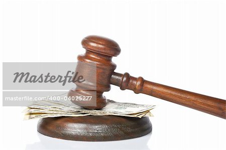 Wooden gavel and dollars bills from the court isolated on white background