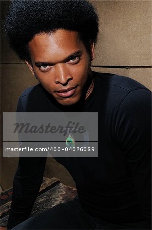 Portrait of young trendy african male model with intense look