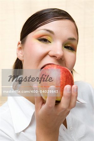 attractive brunette woman holding apple