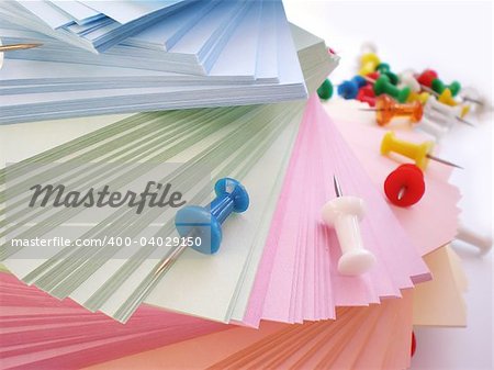 colorful sheets and push pins isolated on white background