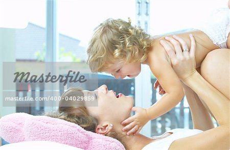 High key portrait of happy mother with baby