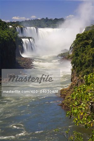 Iguassu Falls is the largest series of waterfalls on the planet, located in Brazil, Argentina, and Paraguay.  At some times during the year one can see as many as 275 separate waterfalls cascading along the edges of 2,700 meters (1.6 miles) cliffs. Argentines spells this wonder, ?Iguazu?, the Brazilians, ?Igaucu.? Both versions are globally correct and widely used. South America