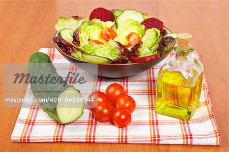 Mediterranean salad with lettuce tomatoes cucumber oil and beet. Shallow depth of field