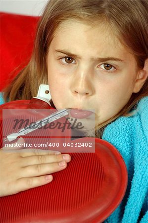 Sick child with thermometer and hot water bottle.