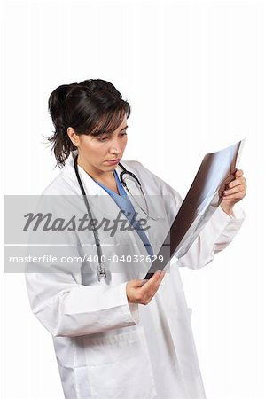 Friendly female doctor in lab coat , examining x-ray against white background