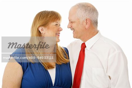 Happy mature married couple who are still best friends.  Isolated on white.