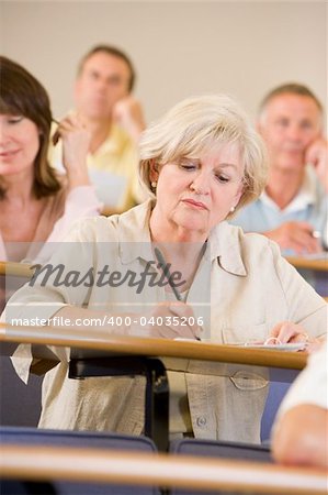 Senior woman listening to a university lecture