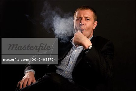 man in suit smoking tobacco-pipe