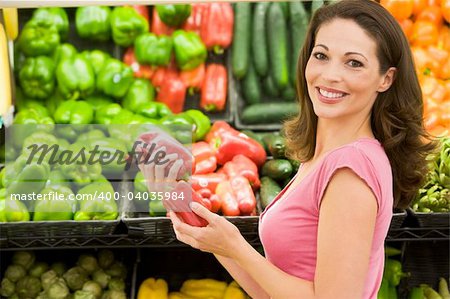 Woman shopping in produce section of supermarket