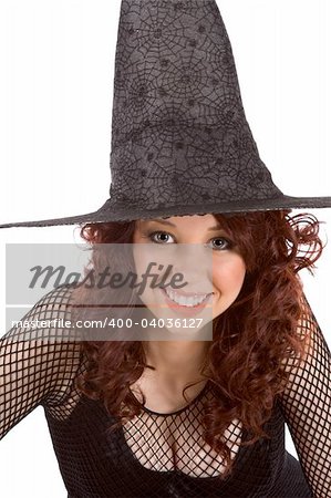 Portrait of busty Latina teenager girl in black Halloween hat and fishnet dress