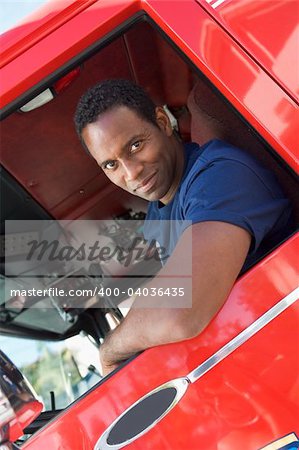 A firefighter sitting in the cab of a fire engine