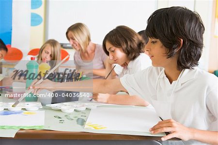 Schoolchildren and their teacher in an art class