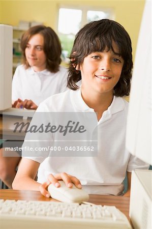 Schoolboy studying in front of a school computer