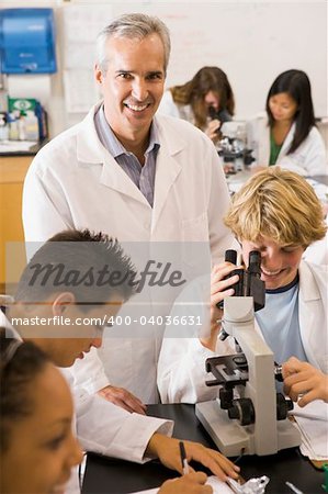 School children and their teacher in a high school science class